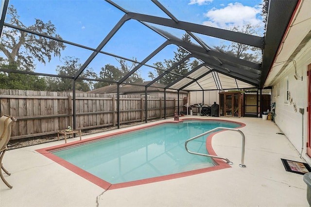 view of swimming pool featuring glass enclosure and a patio area