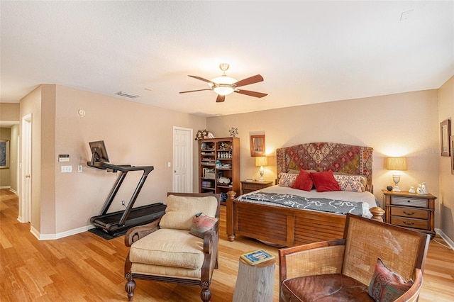 bedroom with ceiling fan and light hardwood / wood-style floors