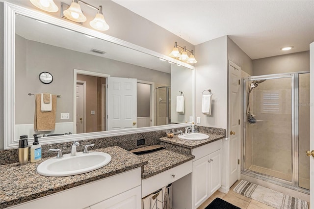 bathroom featuring vanity, tile patterned flooring, and walk in shower