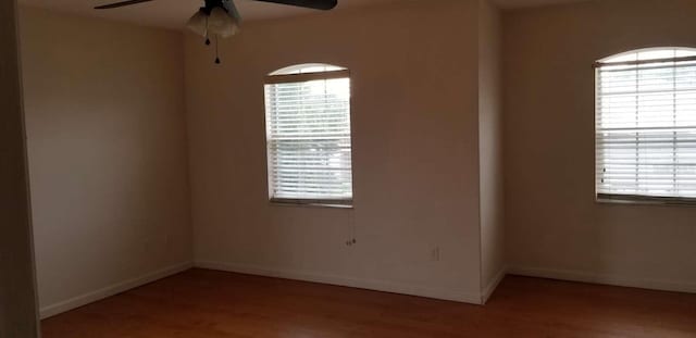 empty room with light wood-type flooring and ceiling fan