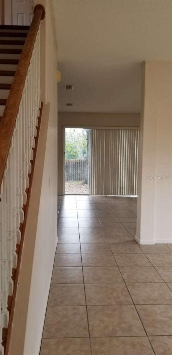 hall featuring light tile patterned floors