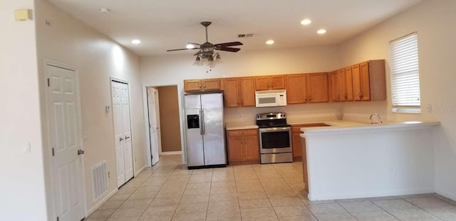 kitchen featuring ceiling fan, light tile patterned floors, sink, and stainless steel appliances