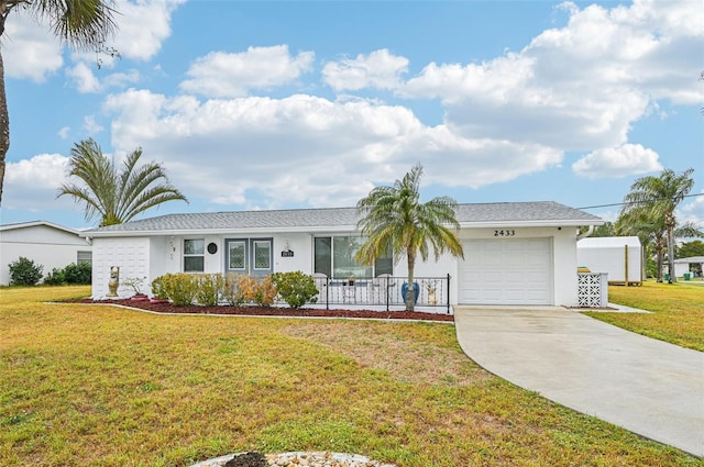 single story home featuring a garage and a front lawn