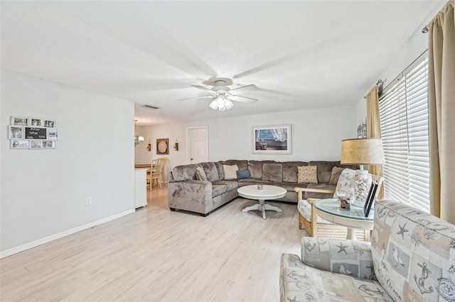 living room with ceiling fan and light wood-type flooring