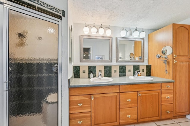 bathroom with an enclosed shower, tile patterned flooring, a textured ceiling, and backsplash