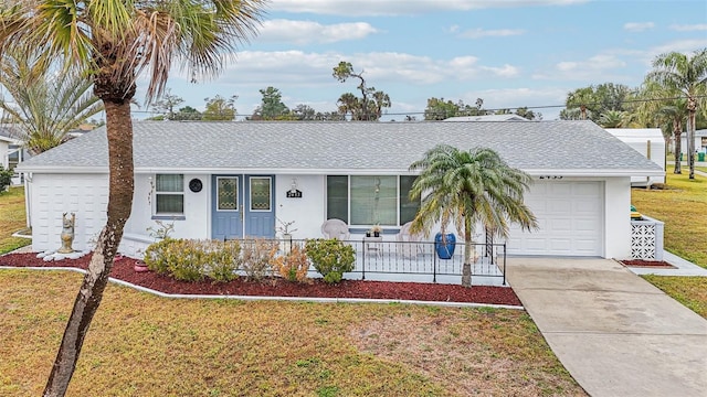 single story home featuring a garage and a front yard