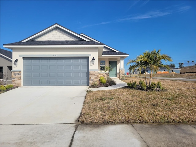 view of front of home with a front yard and a garage