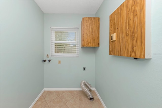 clothes washing area with light tile patterned floors, electric dryer hookup, baseboards, and a textured ceiling