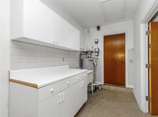 interior space with tile walls and electric water heater