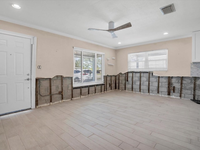 unfurnished room with ceiling fan, light wood-type flooring, and ornamental molding