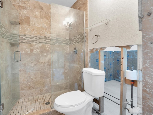 bathroom with an enclosed shower and toilet