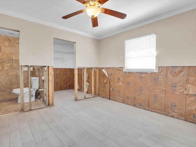 spare room featuring ceiling fan, crown molding, and light hardwood / wood-style floors