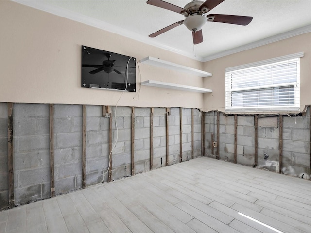 basement featuring light hardwood / wood-style flooring and crown molding