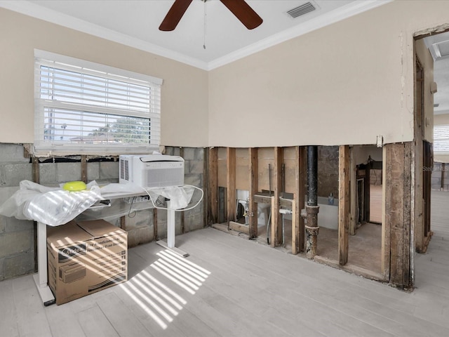 miscellaneous room with ceiling fan, cooling unit, ornamental molding, and light wood-type flooring