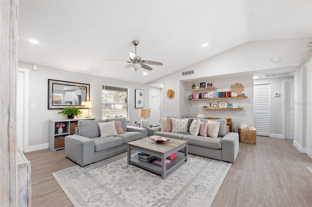 living room with lofted ceiling, light hardwood / wood-style floors, and ceiling fan