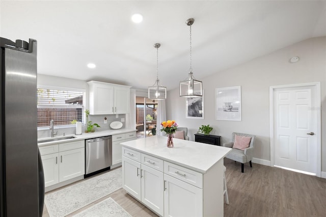 kitchen with white cabinetry, sink, lofted ceiling, and appliances with stainless steel finishes