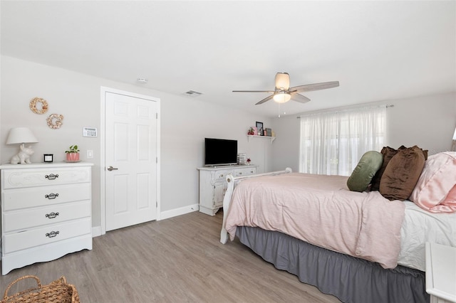 bedroom with light hardwood / wood-style flooring and ceiling fan