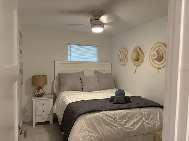 bedroom with ceiling fan and hardwood / wood-style flooring