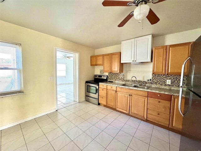 kitchen featuring appliances with stainless steel finishes, sink, decorative backsplash, and plenty of natural light