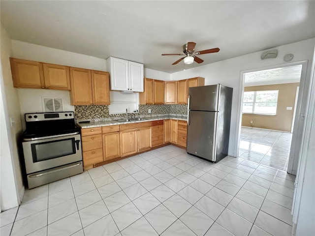 kitchen featuring tasteful backsplash, appliances with stainless steel finishes, sink, and ceiling fan