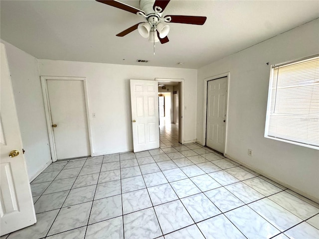 unfurnished bedroom featuring ceiling fan and light tile patterned floors