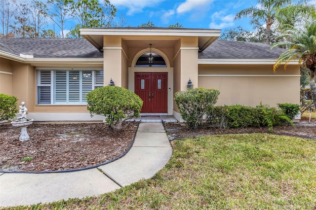 doorway to property featuring a yard