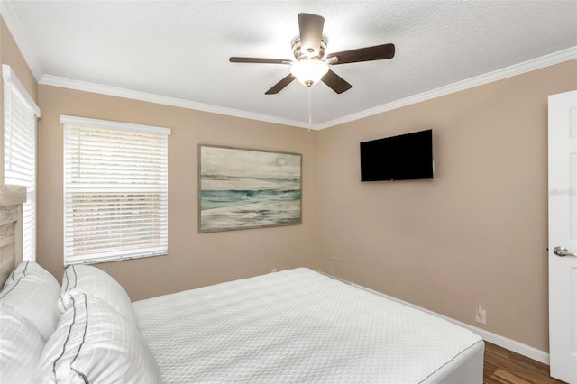 bedroom featuring a textured ceiling, ceiling fan, crown molding, and hardwood / wood-style floors