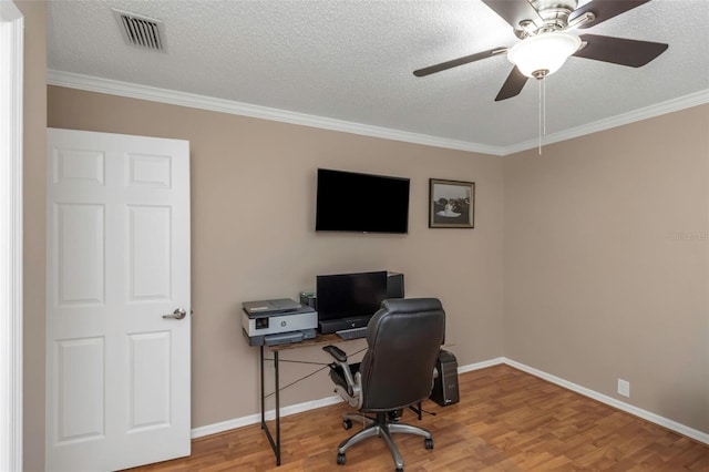 office area with ceiling fan, a textured ceiling, ornamental molding, and hardwood / wood-style flooring