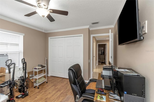 office space with light hardwood / wood-style floors, a textured ceiling, crown molding, and ceiling fan