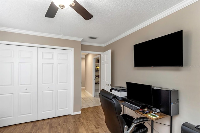 office space featuring ceiling fan, crown molding, a textured ceiling, and light hardwood / wood-style flooring