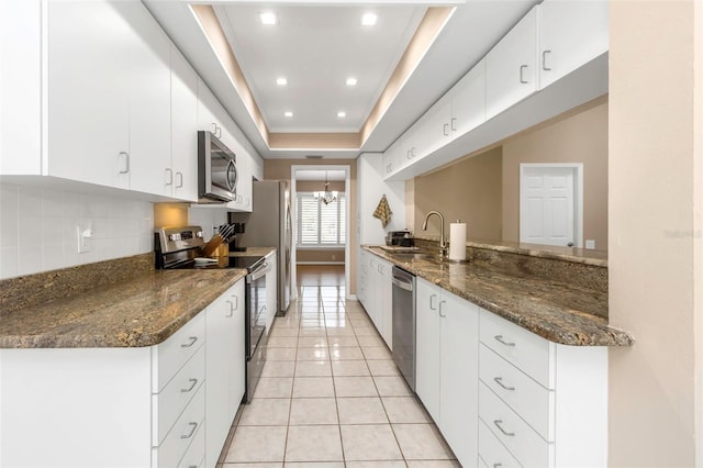 kitchen featuring white cabinets and appliances with stainless steel finishes