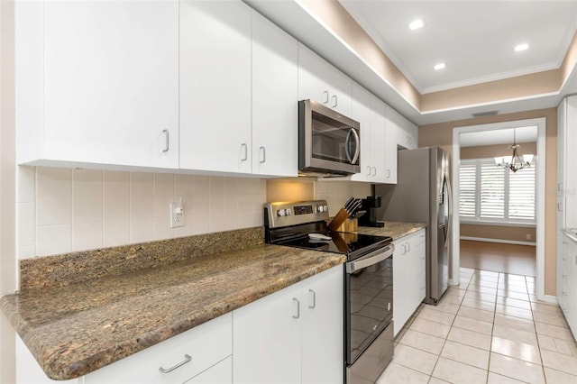 kitchen featuring light tile patterned flooring, white cabinetry, appliances with stainless steel finishes, and tasteful backsplash