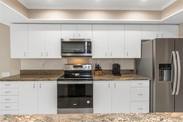 kitchen with stainless steel appliances, backsplash, and white cabinetry