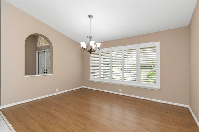 empty room featuring an inviting chandelier