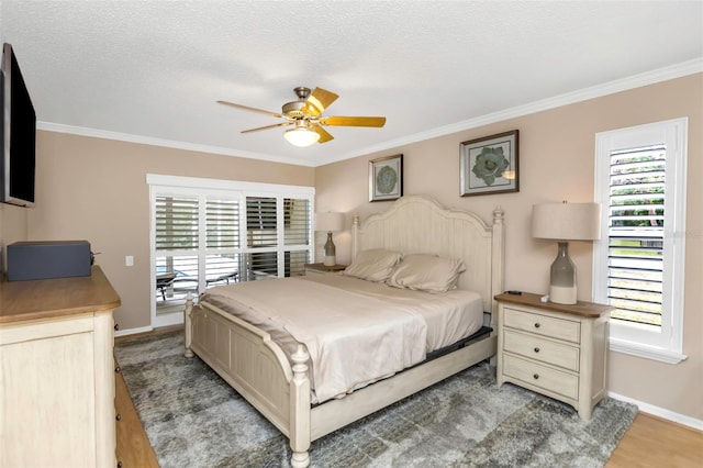 bedroom with a textured ceiling, ceiling fan, ornamental molding, and hardwood / wood-style flooring