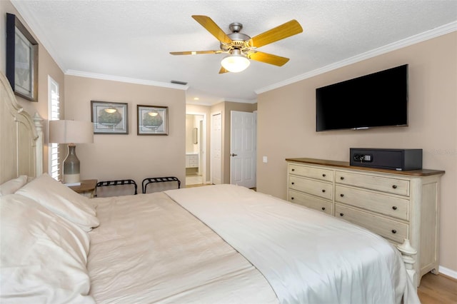 bedroom with ceiling fan, crown molding, light hardwood / wood-style flooring, a textured ceiling, and connected bathroom