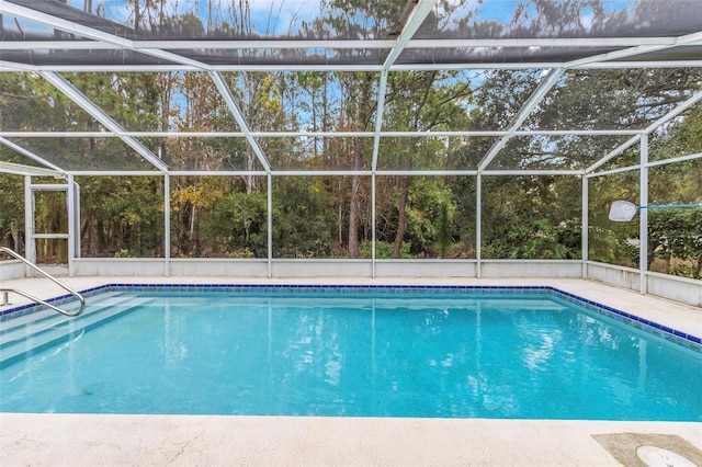 view of pool featuring glass enclosure