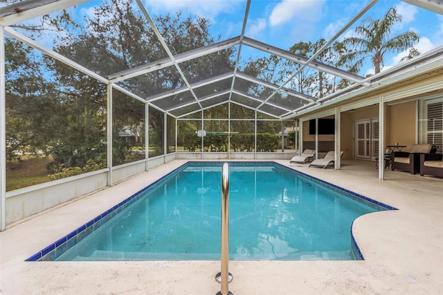 view of pool with a lanai and a patio area