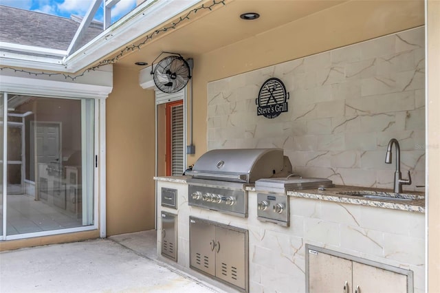 view of patio / terrace with area for grilling and sink