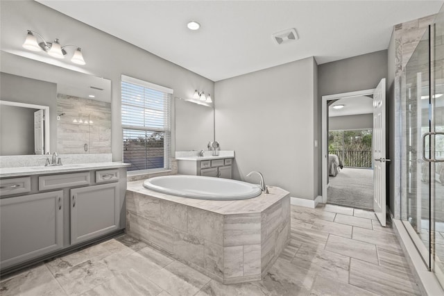 bathroom with vanity, shower with separate bathtub, and a wealth of natural light