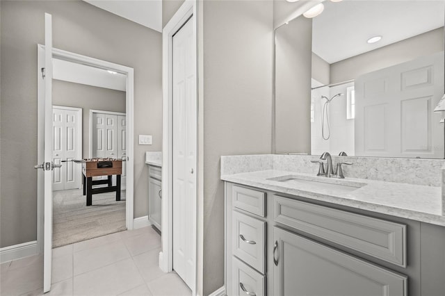 bathroom featuring vanity, tile patterned floors, and walk in shower