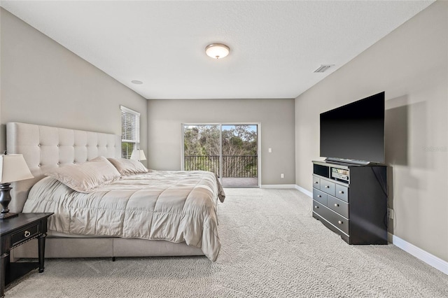 bedroom with light colored carpet and access to exterior