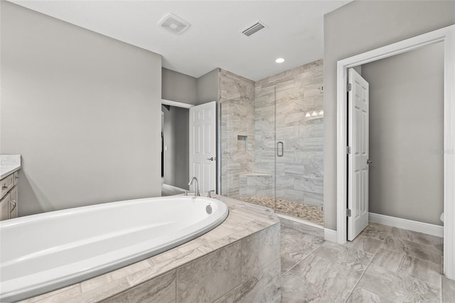 bathroom featuring vanity and separate shower and tub