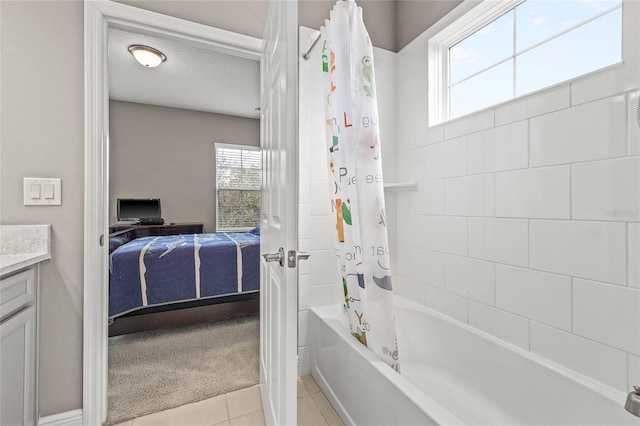 bathroom featuring tile patterned flooring, vanity, shower / tub combo with curtain, and a textured ceiling