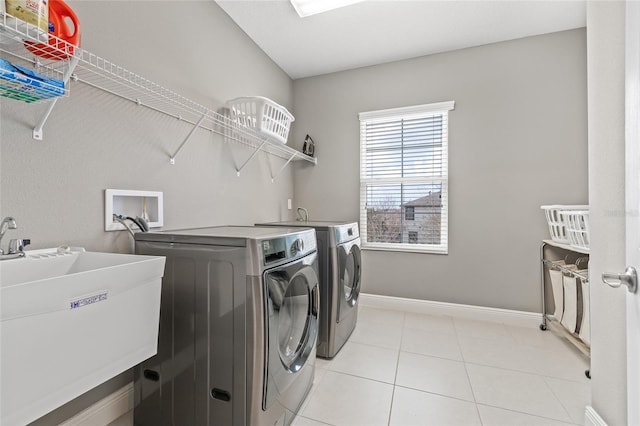 6307 Brevada Ln, Apollo Beach, FL 33572 - washroom with separate washer and dryer, light tile patterned flooring, and baseboards
