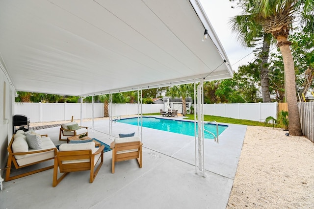 view of pool featuring a patio area, a fenced in pool, outdoor lounge area, and a fenced backyard