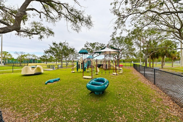 communal playground with a yard and fence