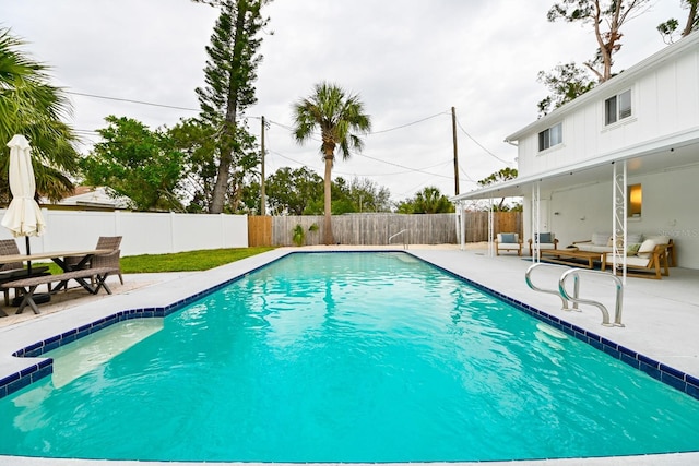 view of pool with a fenced backyard, an outdoor living space, a fenced in pool, and a patio