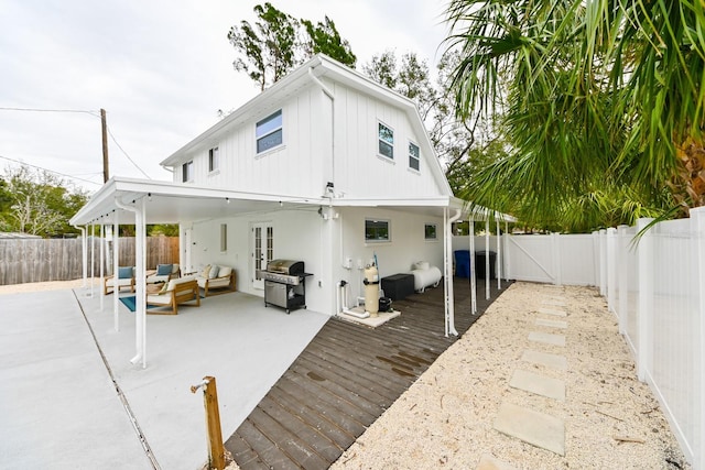 back of house featuring a gate, a patio, a fenced backyard, outdoor lounge area, and a wooden deck