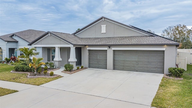 view of front of home featuring a front lawn and a garage